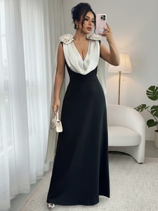 Detail of elegant V-neck gown featuring contrast bodice and 3D floral accents on shoulders
