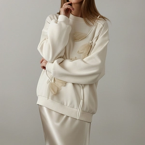 Chic beige sweatshirt with 3D tulle flowers paired with an elegant champagne satin skirt