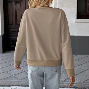 Close-up of khaki oversized long-sleeve sweatshirt with ribbed cuffs and stitching details
