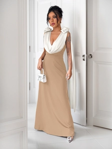 Detail of the deep V-neckline with 3D floral accents and elegant white ribbons