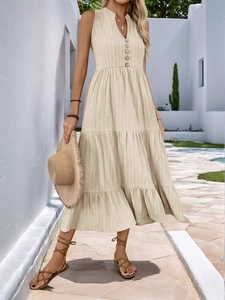 Detail of beige V-neck dress showing textured fabric and decorative wooden buttons