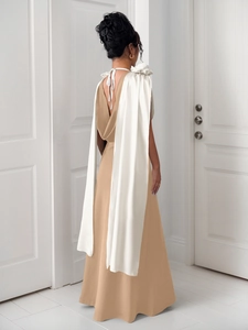 Detail of the elegant V-neck backless evening gown with a large white satin bow accent