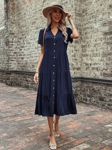 Detail of navy blue short sleeve button-down tiered midi dress with a V-neckline