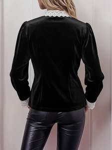 Detail of vintage black velvet shirt with white lace cuffs and slimming back waist design