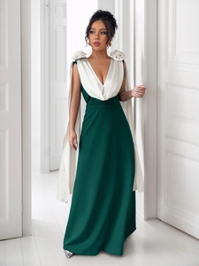 Detailed view of the elegant deep green evening gown with white V-neck floral embellishments