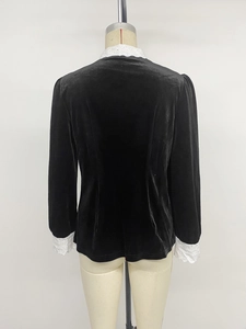 Detail view of the black velvet shirt back featuring white lace collar and vintage trim