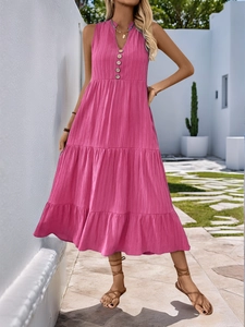 Detailed view of fuchsia tiered maxi dress with V-neckline and wooden button accents