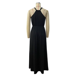 Detail of the backless design and elastic waist on this black halter maxi dress