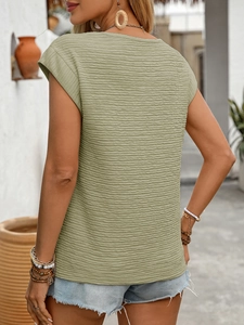 Detail of light green textured T-shirt with horizontal pleats and back view outdoor