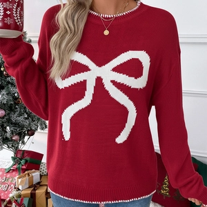 Detail of red Christmas knit sweater featuring white bow jacquard and festive collar stitching