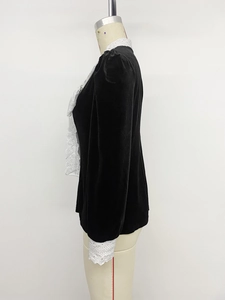 Detailed side view of black velvet shirt with vintage white lace collar and cuffs