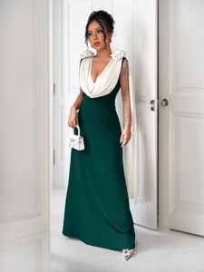 Detail view of the elegant deep V-neckline and 3D white rose flowers on the evening dress