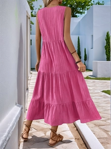 Detail of a tiered rose pink sleeveless maxi dress with vertical pleated fabric texture