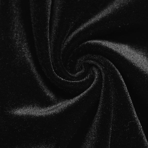 Macro shot showing premium black velvet fabric texture with soft glossy sheen and drape