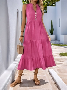 Detail of rose pink V-neck sleeveless dress featuring wood buttons and tiered cake skirt