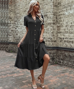 Detail of a black short-sleeve lapel dress featuring a three-layer tiered cake skirt design
