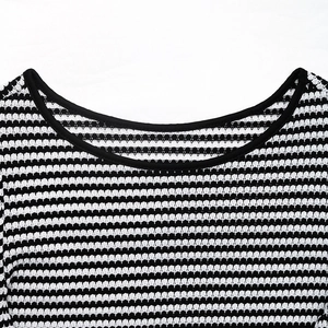 Close-up detail of the classic round neckline with black piping on striped knit t-shirt