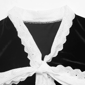 Close-up of vintage black velvet blouse featuring delicate white lace collar and bow tie