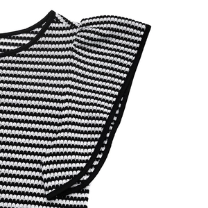 Detailed view of striped textured fabric and black trim on the ruffle flutter sleeves