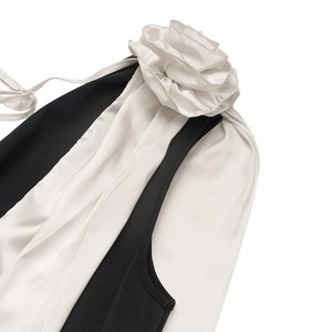 Detail of elegant V-neck dress with handmade satin rose and silk contrast texture
