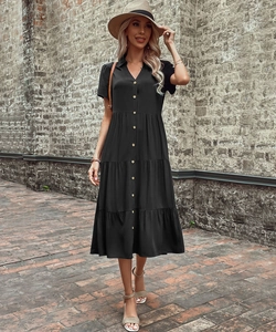 Detail view of the layered tier skirt and button-down front on a black midi dress
