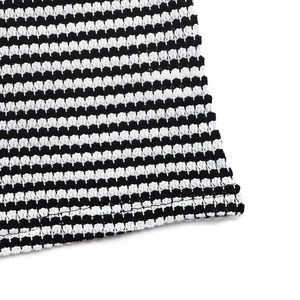 Detailed close-up of textured black and white striped fabric showing fine knit material