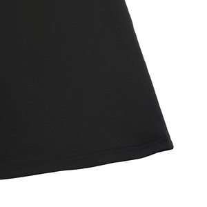 Detailed macro view of the double-needle hem on a black V-neck sleeveless dress fabric