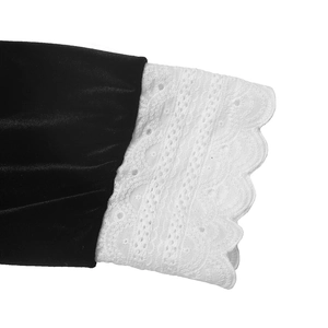 Detailed close-up of vintage black velvet sleeves with intricate white lace embroidery