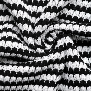 Close-up of high-quality black and white striped knit fabric with soft texture