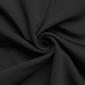 Macro shot showing the elegant drape and fine woven texture of the black V-neck dress fabric