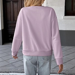 Detail of lavender sweatshirt showing back view with ribbed cuffs and hem on model