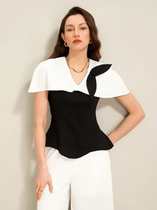 Détail du haut noir élégant avec col châle blanc et nœud décoratif pour femme