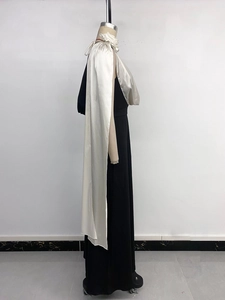 Detail of elegant V-neck dress featuring white satin draping and contrast trim