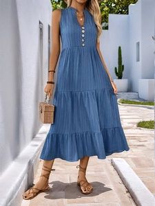 Close-up of sky blue sleeveless pleated dress showing V-neck buttons and tiered design