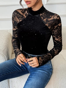 Detail of velvet party bodysuit featuring lace hollow sleeves and sparkling rhinestones