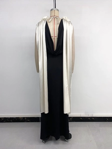 Detail view of the elegant black evening dress featuring a deep V-shaped open back design