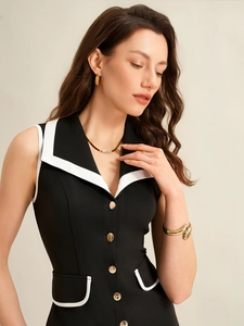 Close-up of gold jewelry set styled with a contrast lapel sleeveless summer dress