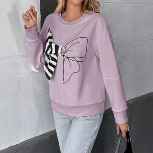 Detail of lavender sweatshirt with mixed-media bow design and striped fabric texture