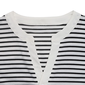 Close-up of V-neckline detail on a black and white striped puff sleeve top