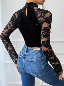 Close-up of velvet party bodysuit featuring floral lace sleeves and back cutout detail