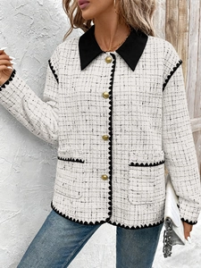 Detail of tweed jacket with contrast black collar and vintage gold buttons for women