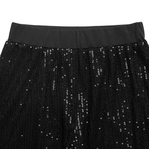 Detail view of high waist elastic band and black sequins on wide leg trousers