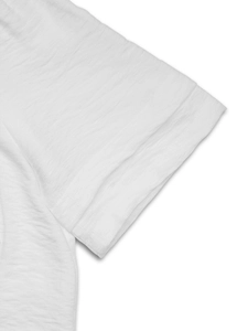 Close-up of white textured summer shirt sleeve with detailed woven crepe fabric texture