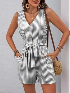 Close-up of black and white striped romper with deep V-neck and wood texture buttons