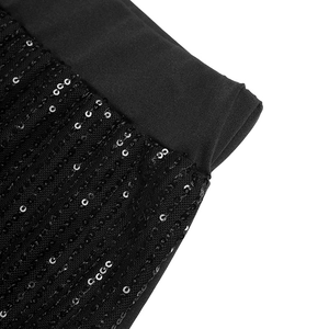 Detail of high waist elastic band and shimmering vertical sequins on black trousers