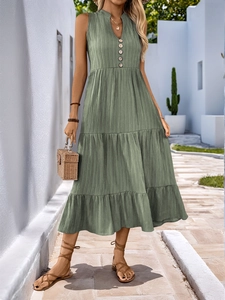 Detail of sage green V-neck dress with button decor and tiered boho long skirt