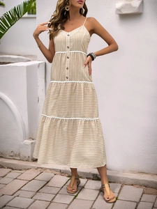 Detailed view of the striped tiered dress with delicate white wave lace stitching details