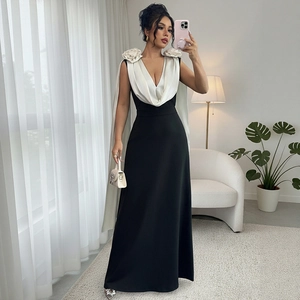 Elegant V-neck black and white contrast evening gown with floral details and matching shawl