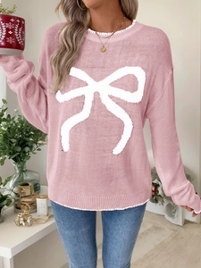 Close-up of ribbed cuffs and soft pink knit texture on women's bow sweater