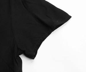 Detail shot of the fine stitching and texture on a black lapel dress sleeve cuff